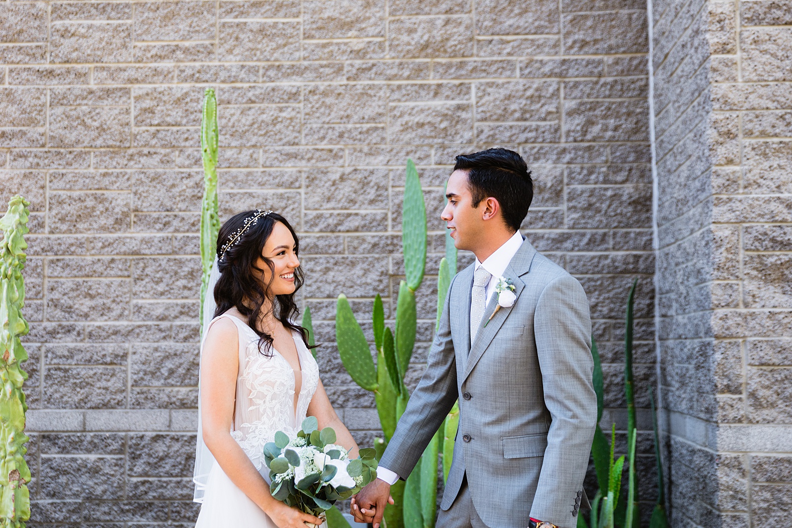 Bride and groom's first look at Hyatt Regency Scottsdale Resort & Spa At Gainey Ranch by Phoenix wedding photographer PMA Photography.