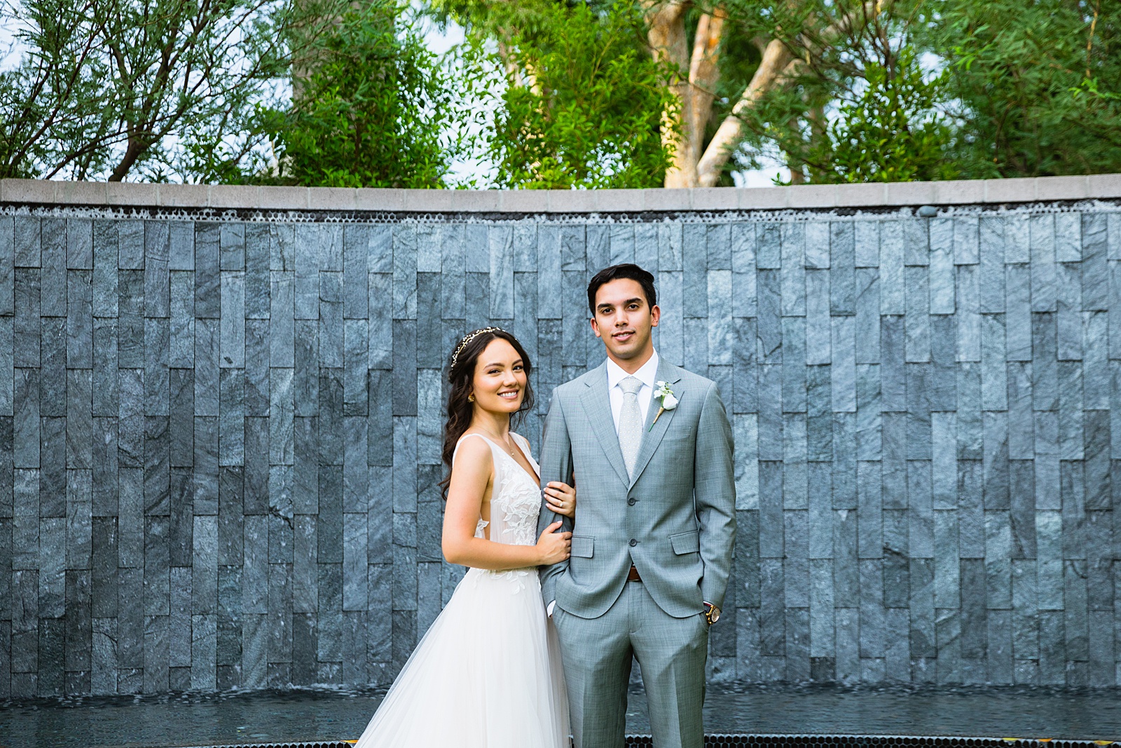 Bride and groom pose during their Hyatt Regency Scottsdale Resort & Spa At Gainey Ranch wedding by Arizona wedding photographer PMA Photography.