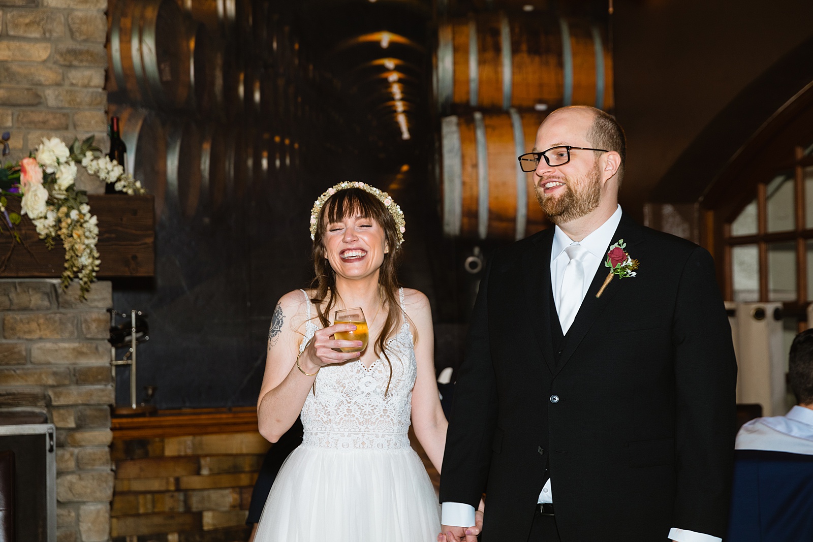 Bride and Groom laughing at their Timo Wood Oven Wine Bar wedding reception by Arizona wedding photographer PMA Photography.