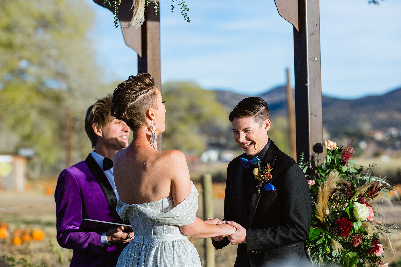 Same sex couple exchange vows during their Mortimer Farms wedding ceremony by Prescott wedding photographer PMA Photography.