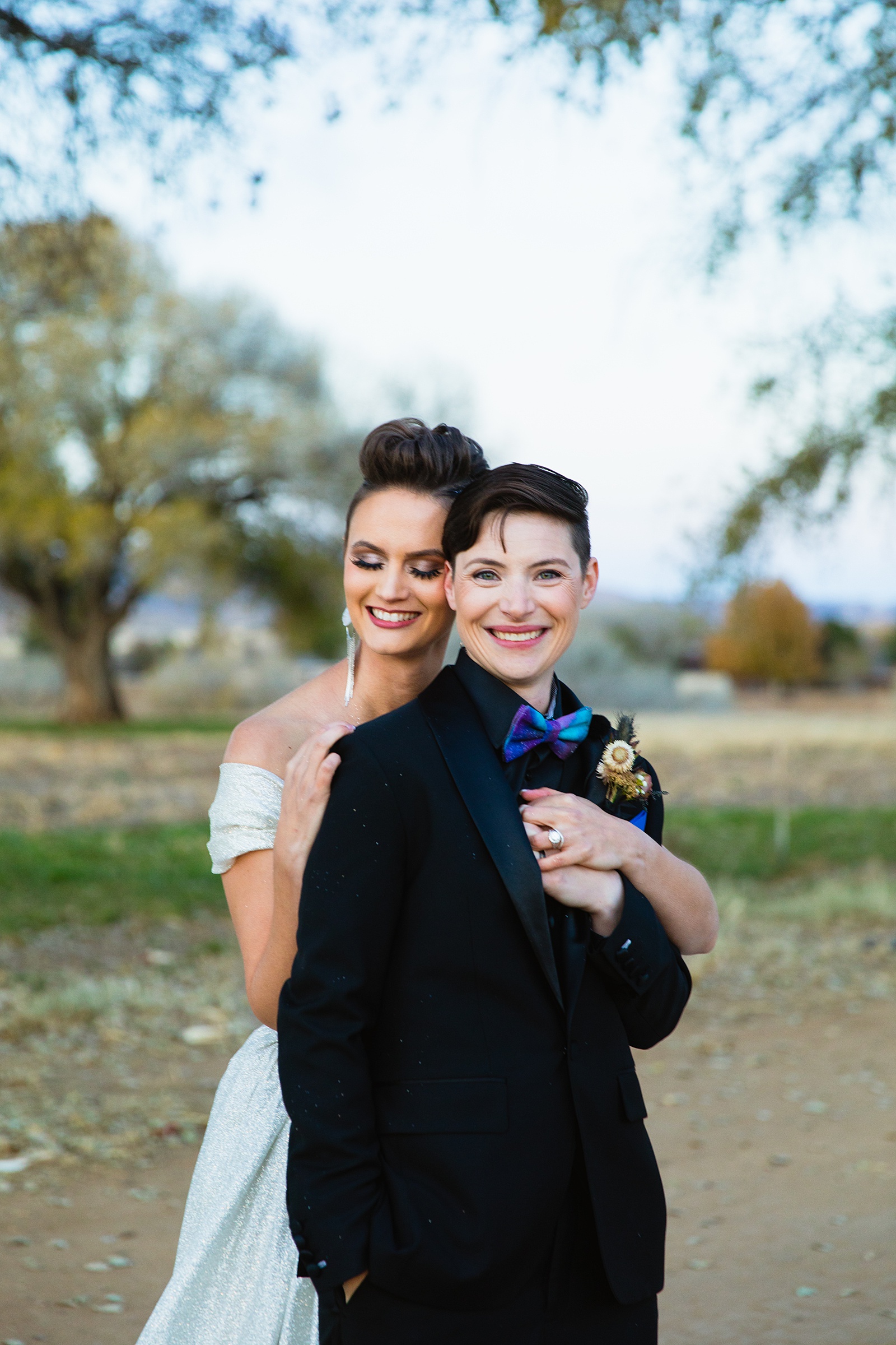 Same sex couple share an intimate moment during their Mortimer Farms wedding by Prescott wedding photographer PMA Photography.