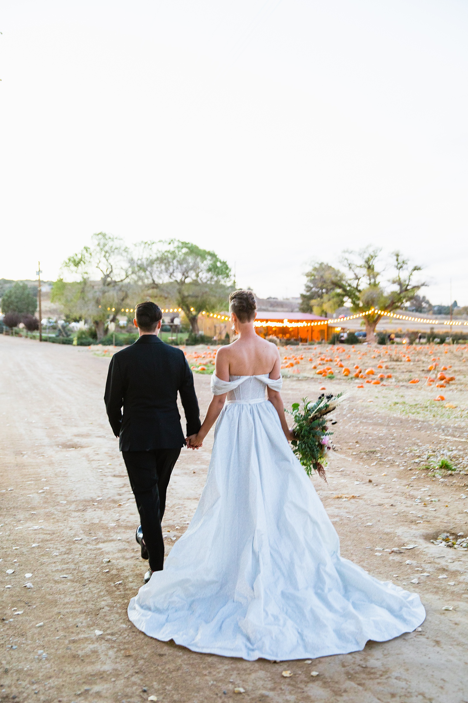 Same sex couple walking together during their Mortimer Farms wedding by Arizona wedding photographer PMA Photography.