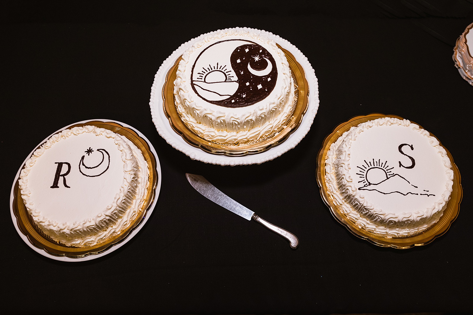 Custom initial, yin yang, and sun and moon designed wedding cakes by Arizona wedding photographer PMA Photography.
