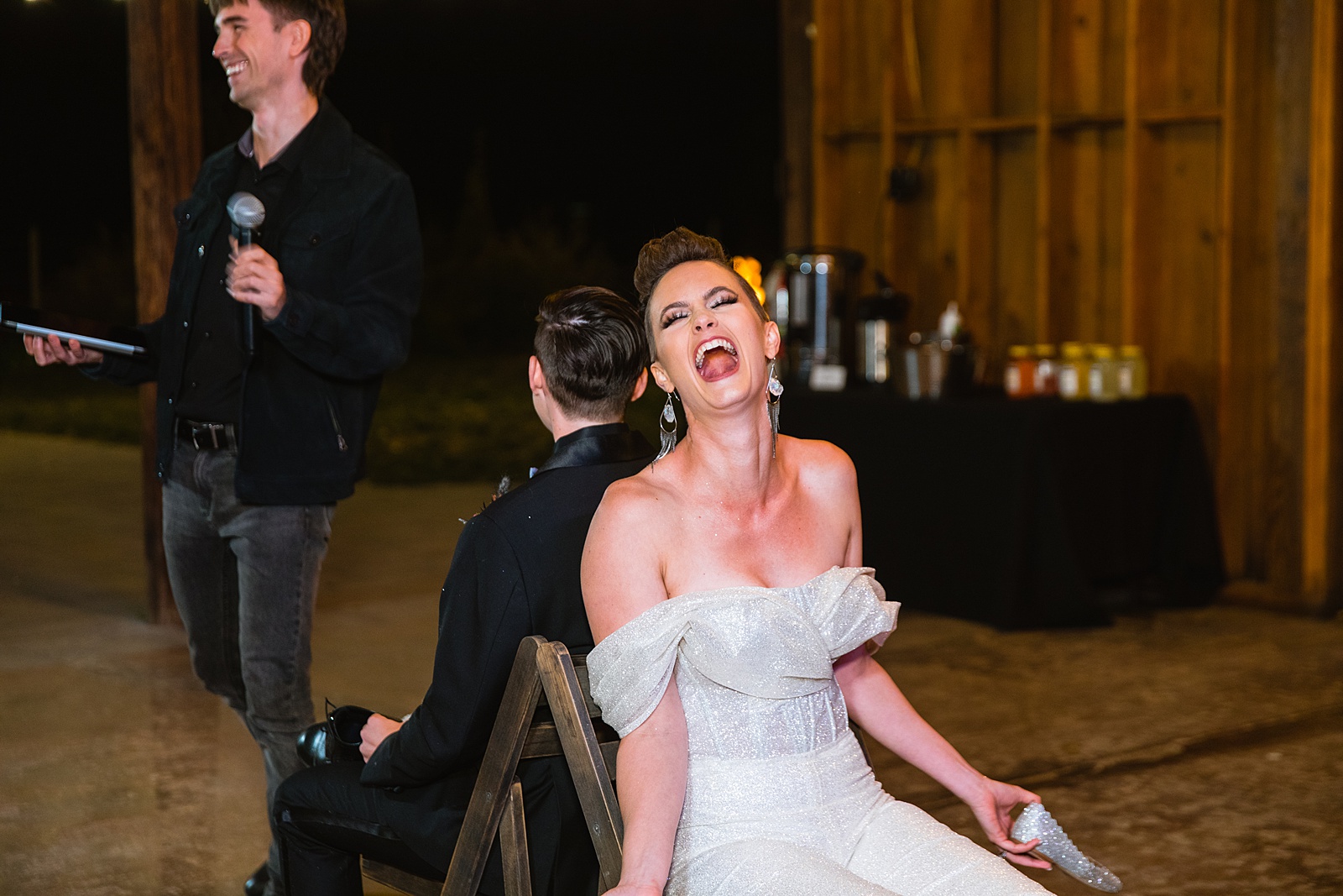 Same sex couple play newlywed game during wedding reception at Mortimer Farms by Arizona wedding photographer PMA Photography.