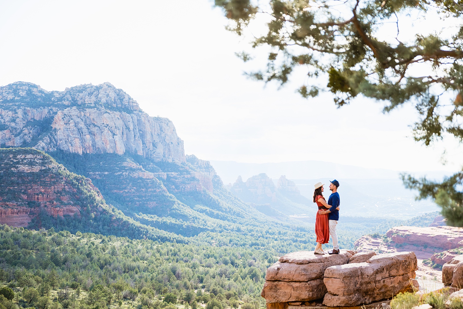 Adventurous look at each other during their Merry Go Round engagement session by Sedona wedding photographer PMA Photography.