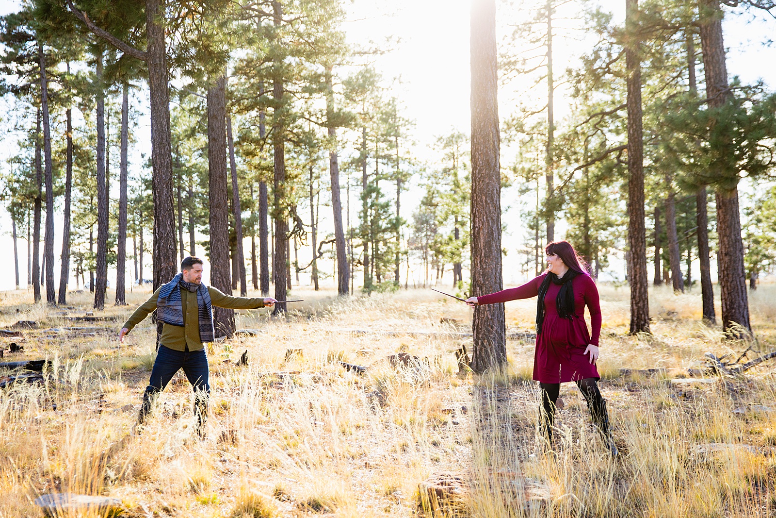 Adventurous couple pose with Harry Potter wands for their Mogollon Rim engagement session by Payson wedding photographer PMA Photography.
