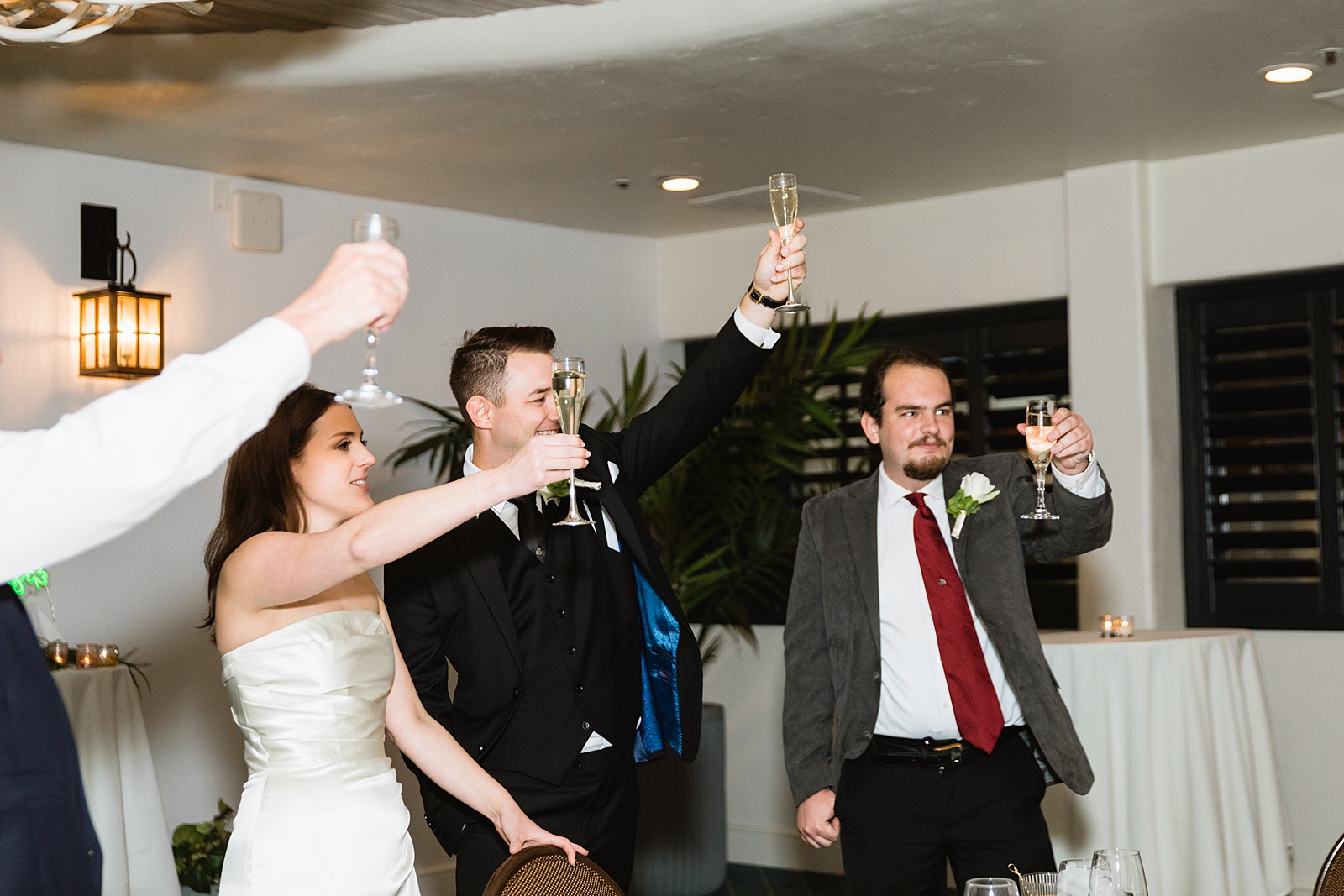 Toasts at The Scott wedding reception by Scottsdale wedding photographer PMA Photography.