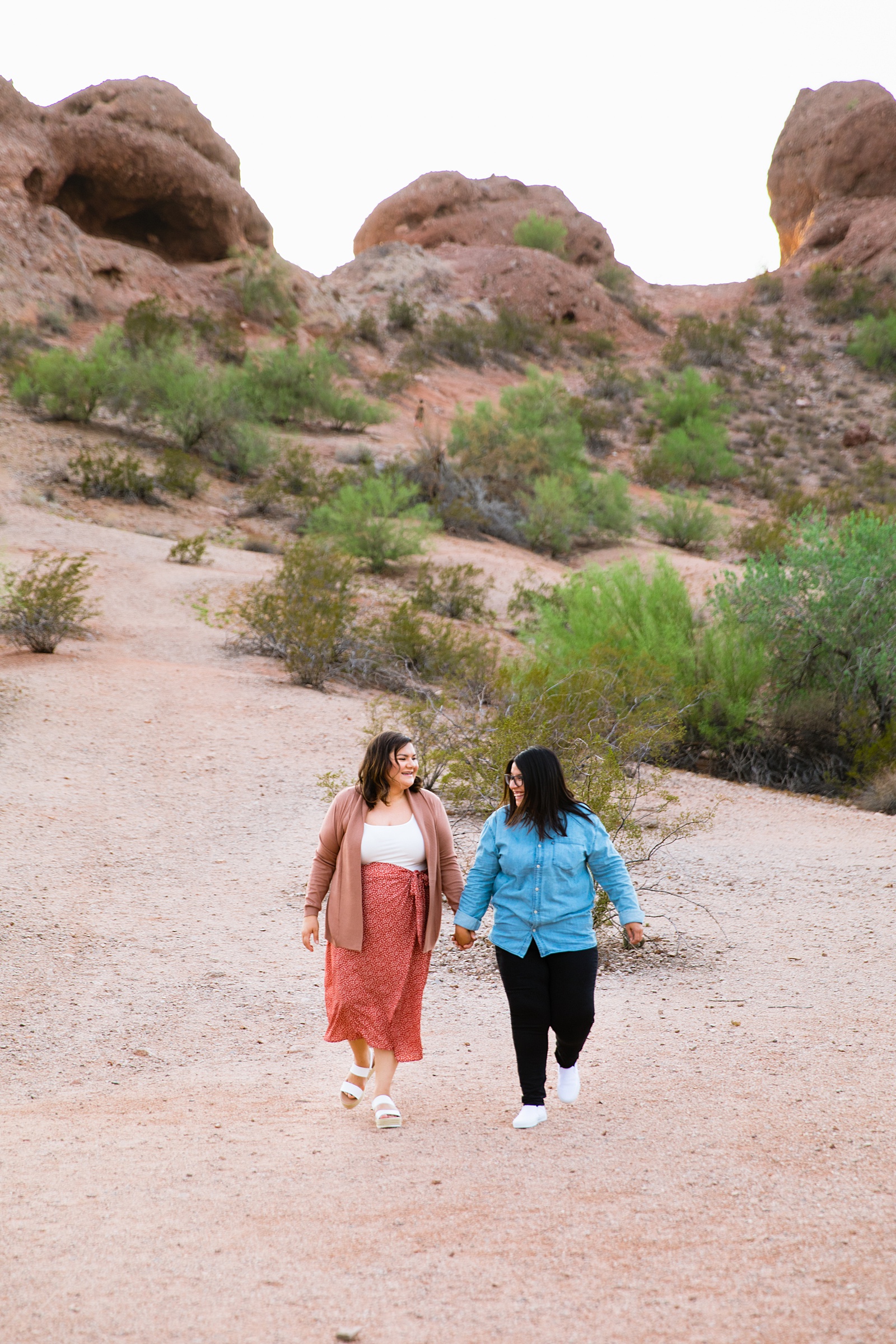 Same sex couple walking together during their Phoenix engagement session by Arizona engagement photographer PMA Photography.