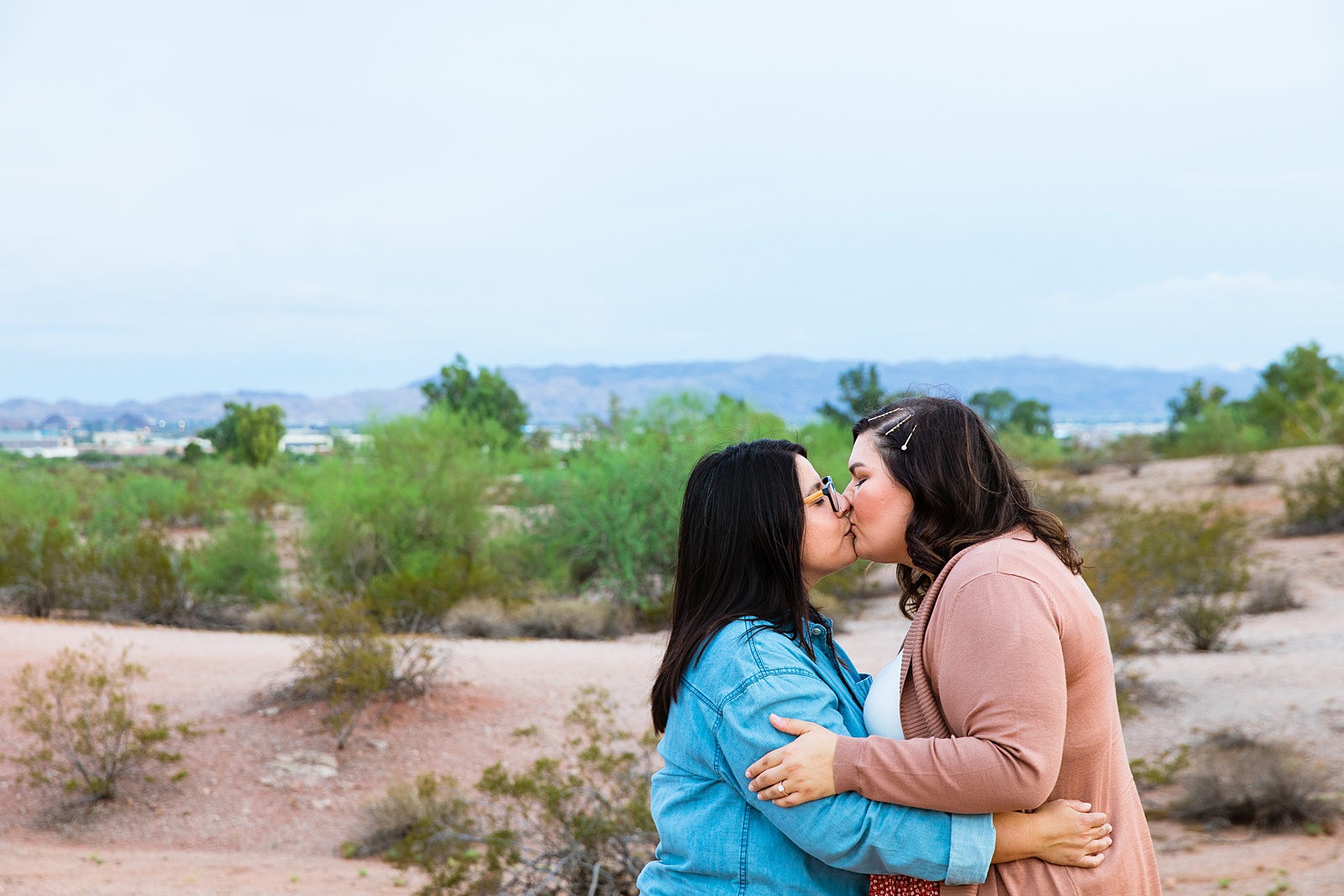 LGBTQ couple share a kiss during their Phoenix engagement session by Arizona wedding photographer PMA Photography.