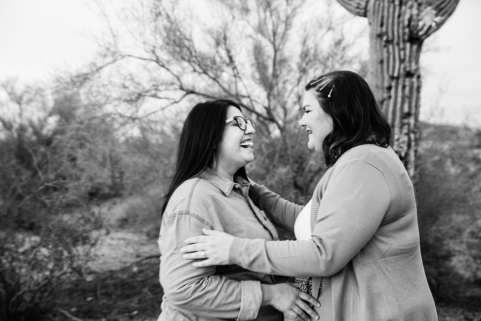 LGBTQ couple laugh together during their Phoenix engagement session by Arizona engagement photographer PMA Photography.
