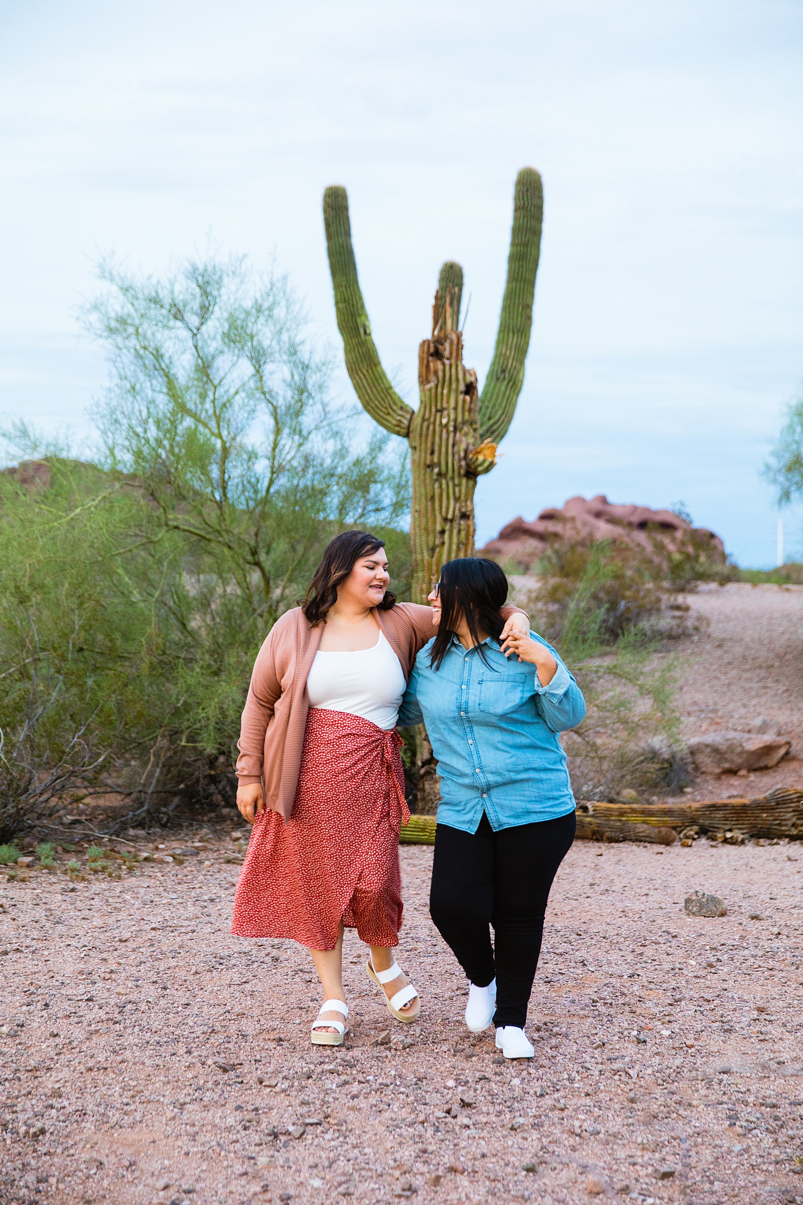LGBTQ couple walking together during their Phoenix engagement session by Arizona engagement photographer PMA Photography.