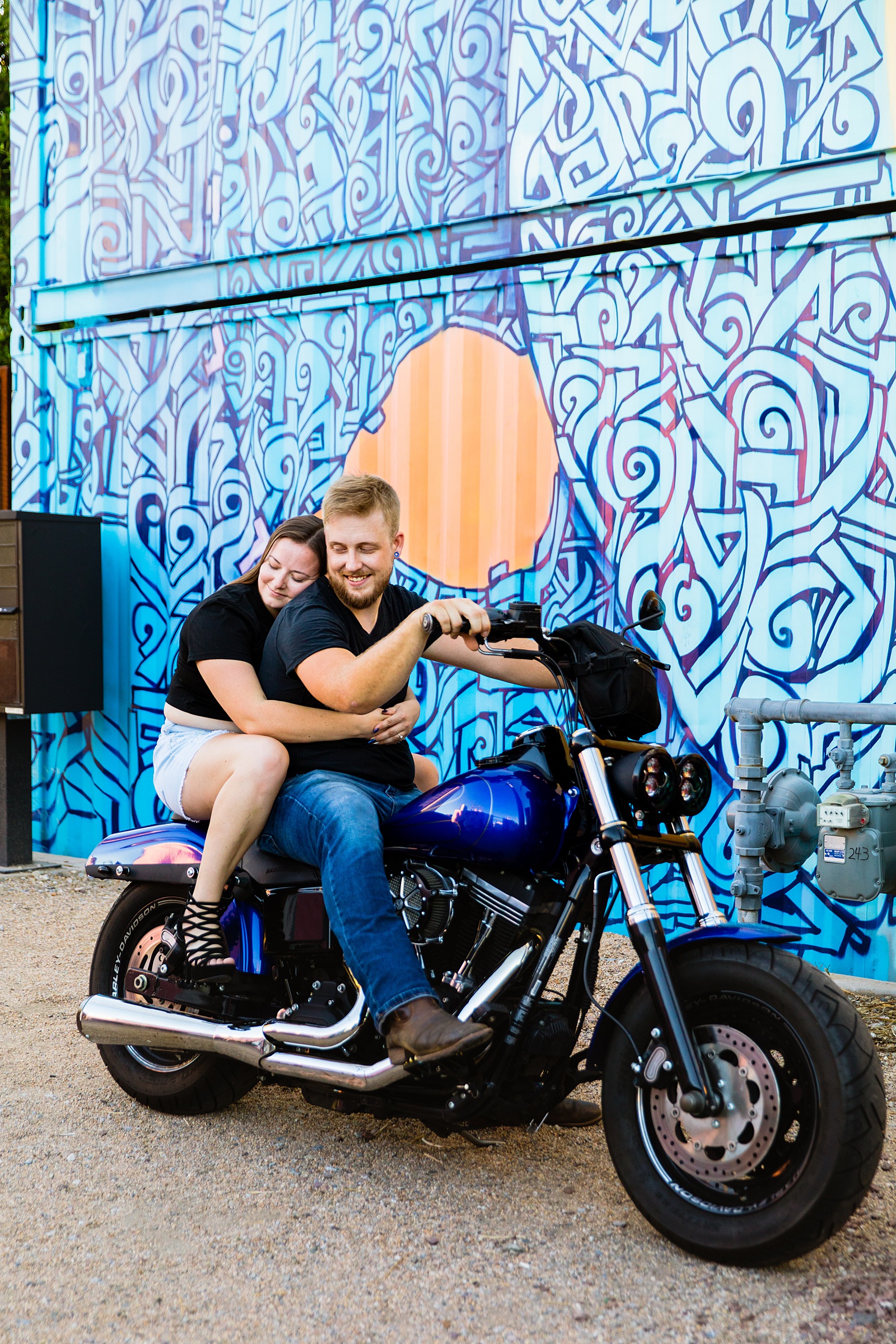 Adventurous couple pose on their motorcycle during their Phoenix engagement session by Arizona wedding photographer PMA Photography.