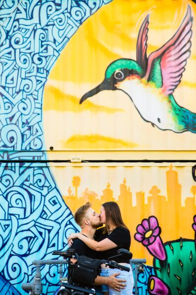 Adventurous couple pose for their Roosevelt Row engagement session by Phoenix wedding photographer PMA Photography.