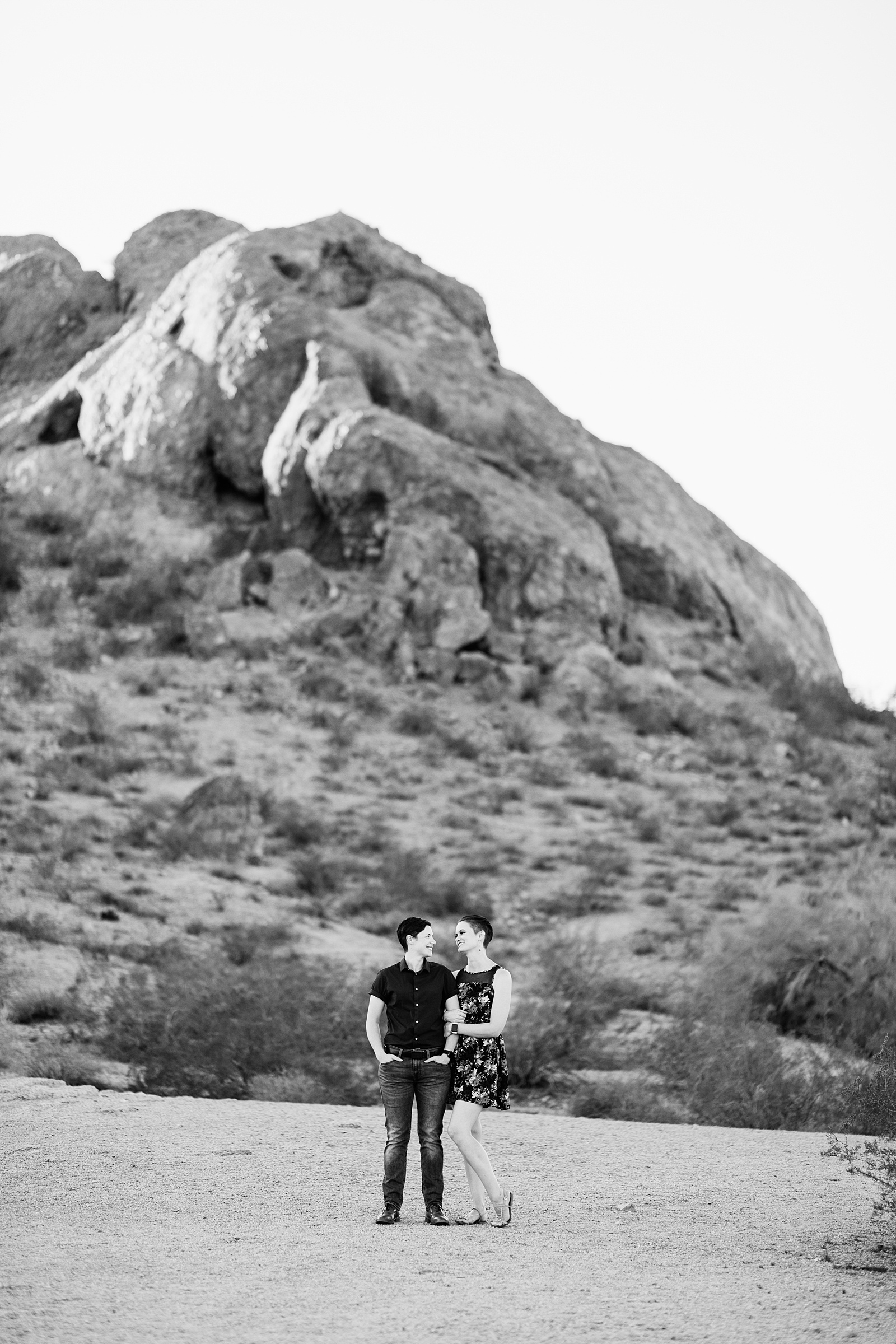 Couple look at each other during their Papago Park engagement session by Phoenix wedding photographer PMA Photography.