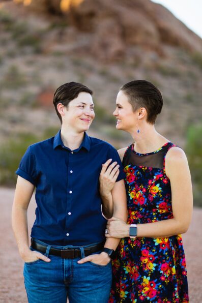 Couple look at each other during their Papago Park engagement session by Phoenix wedding photographer PMA Photography.