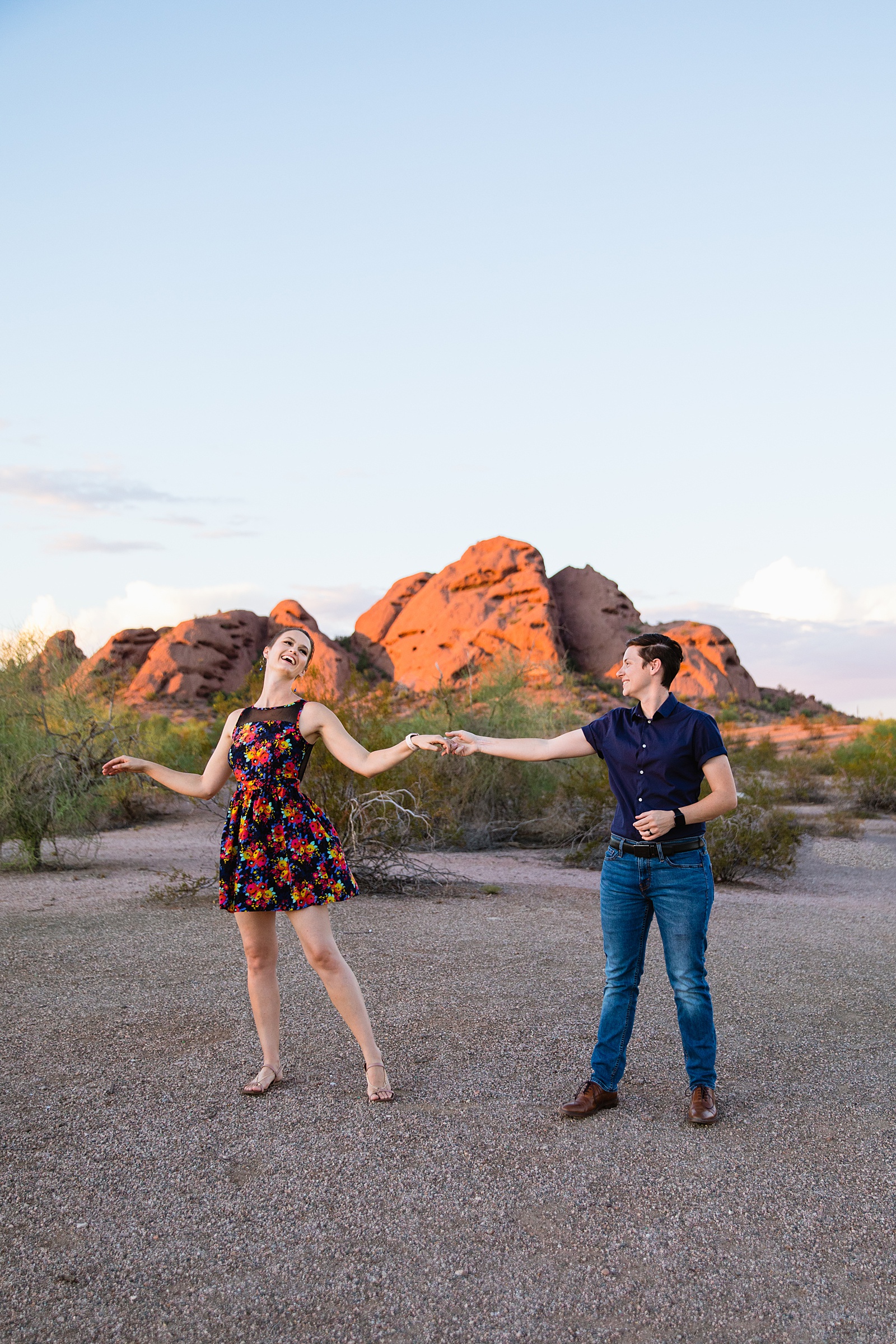 Couple having fun together during their Papago Park engagement session by Phoenix engagement photographer PMA Photography.