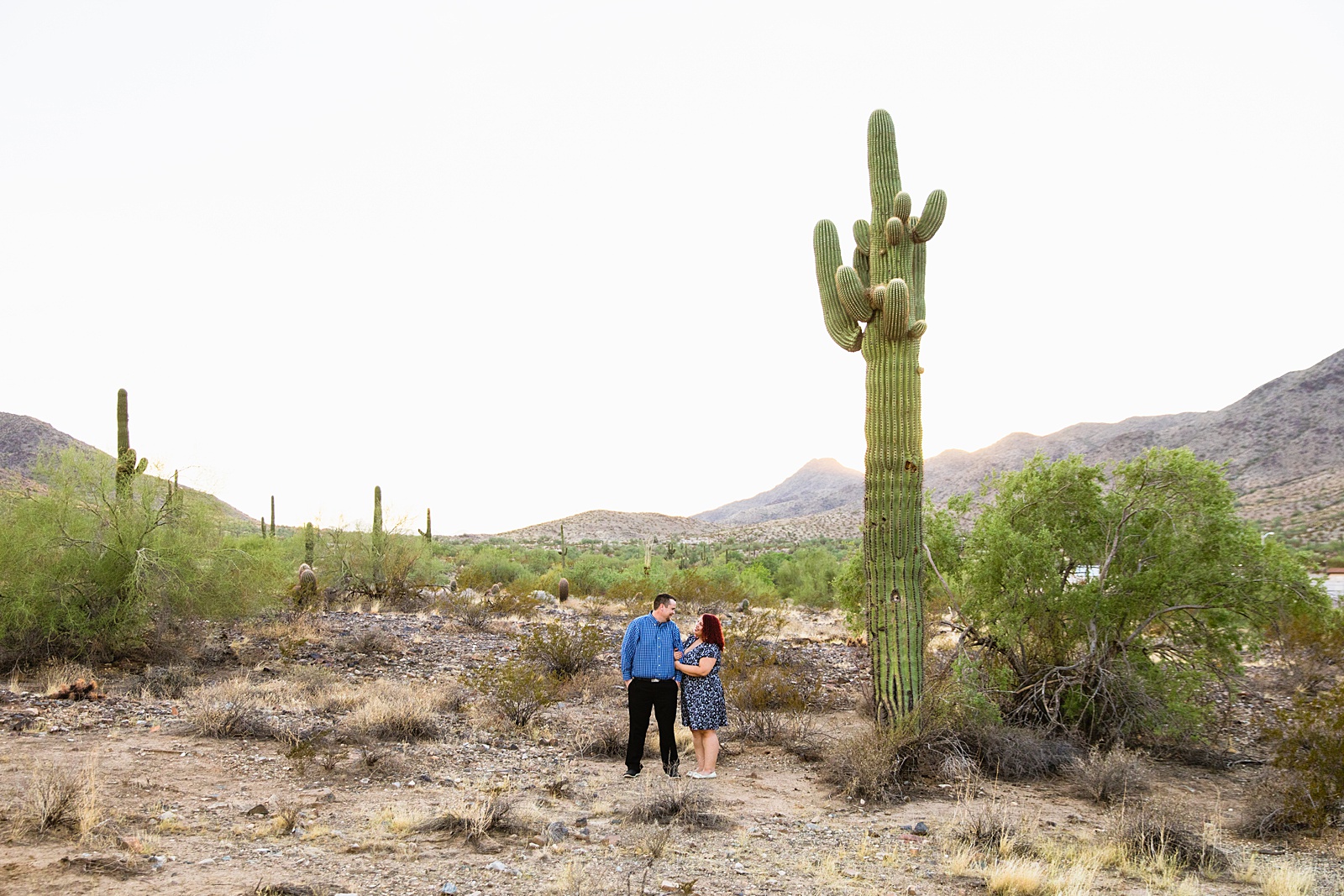 Adventurous couple pose during their Phoenix engagement session by Arizona wedding photographer PMA Photography.