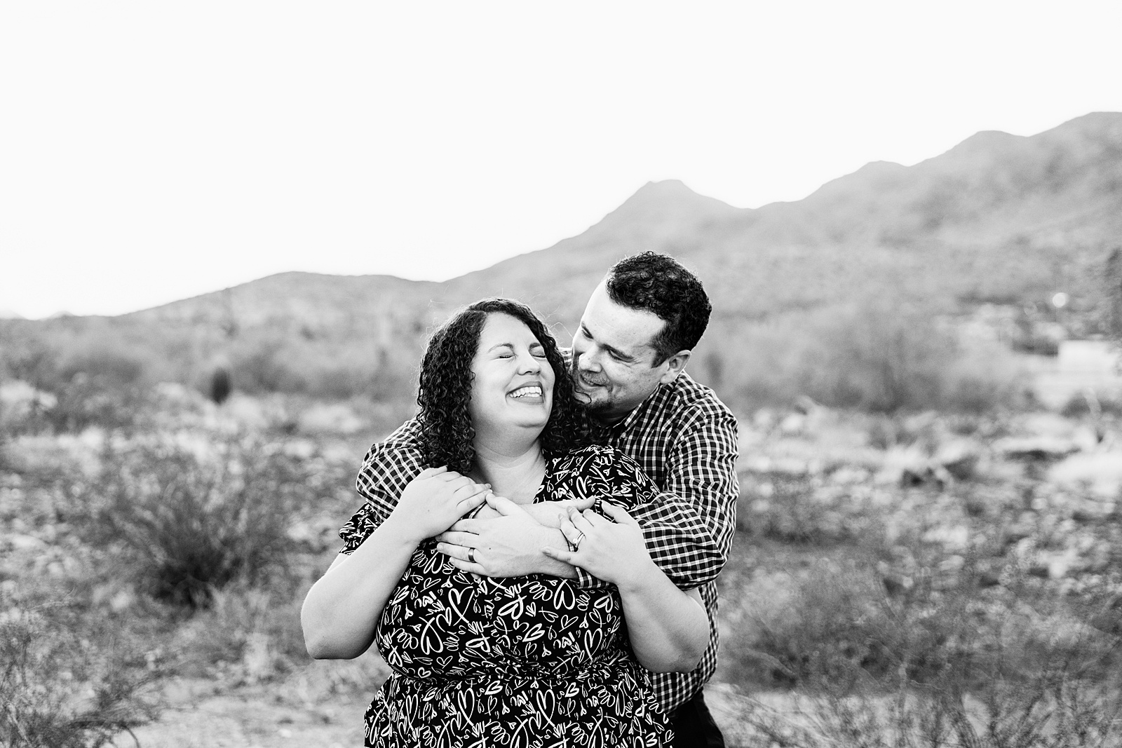 Adventurous couple pose for their South Mountain engagement session by Phoenix wedding photographer PMA Photography.
