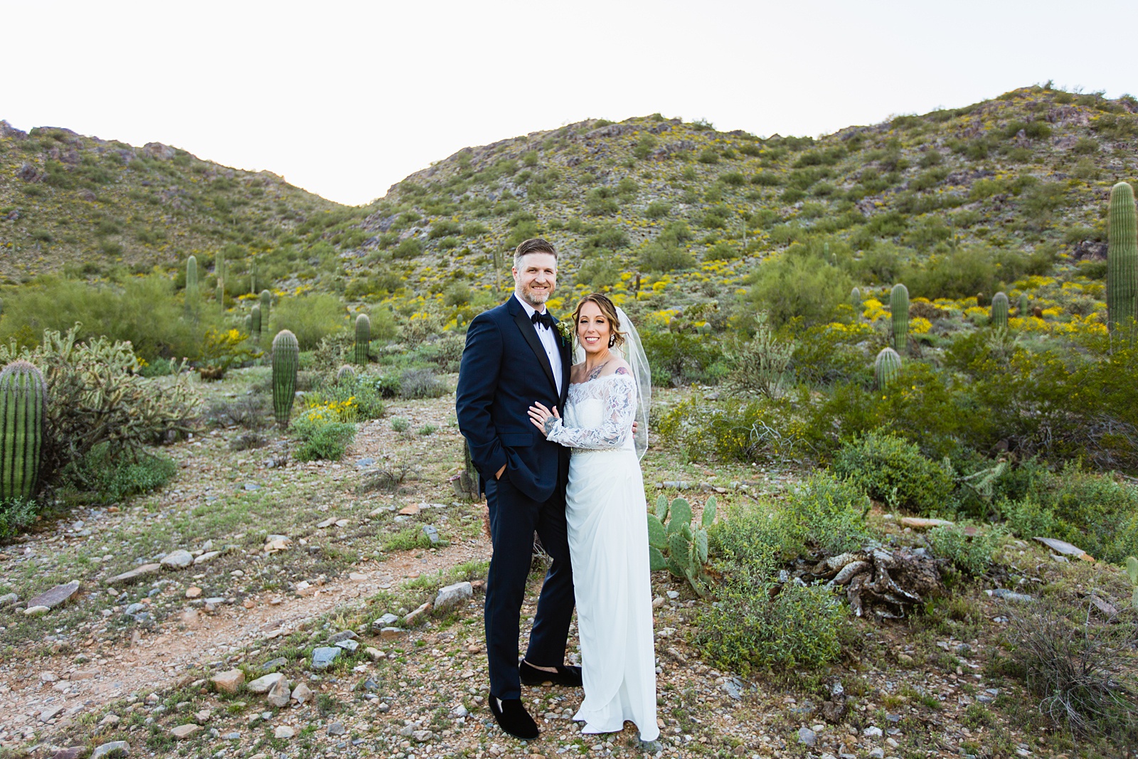 Bride and groom pose during their backyard wedding by Arizona wedding photographer PMA Photography.