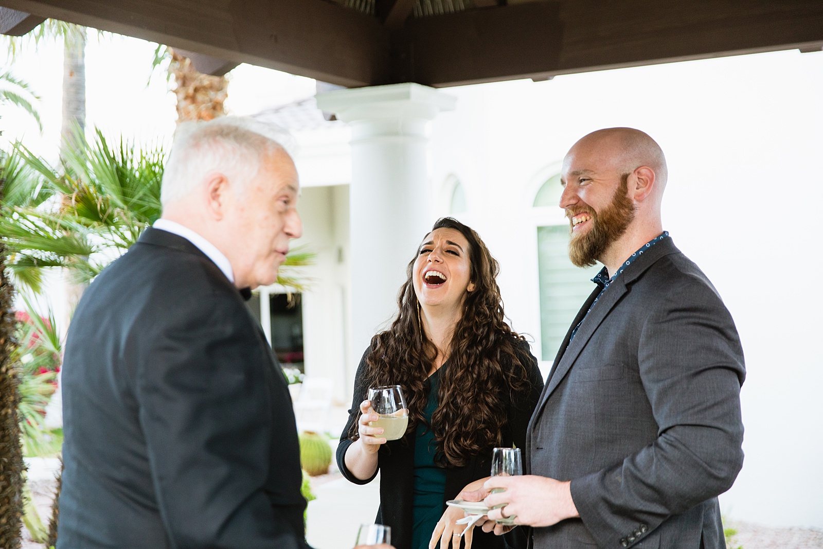Guests together at backyard wedding reception by Scottsdale wedding photographer PMA Photography
