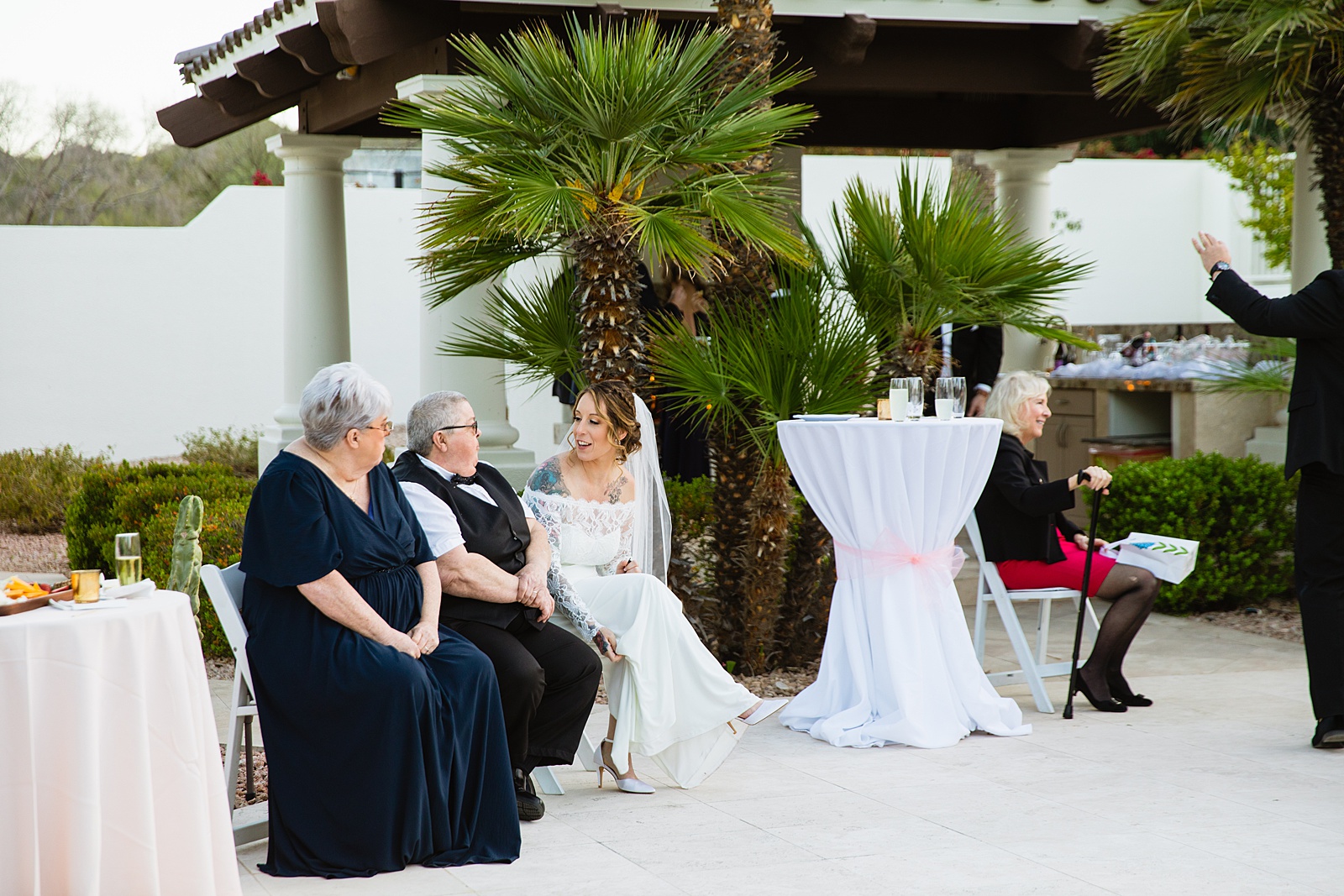 Bride with guests at backyard wedding reception by Scottsdale wedding photographer PMA Photography
