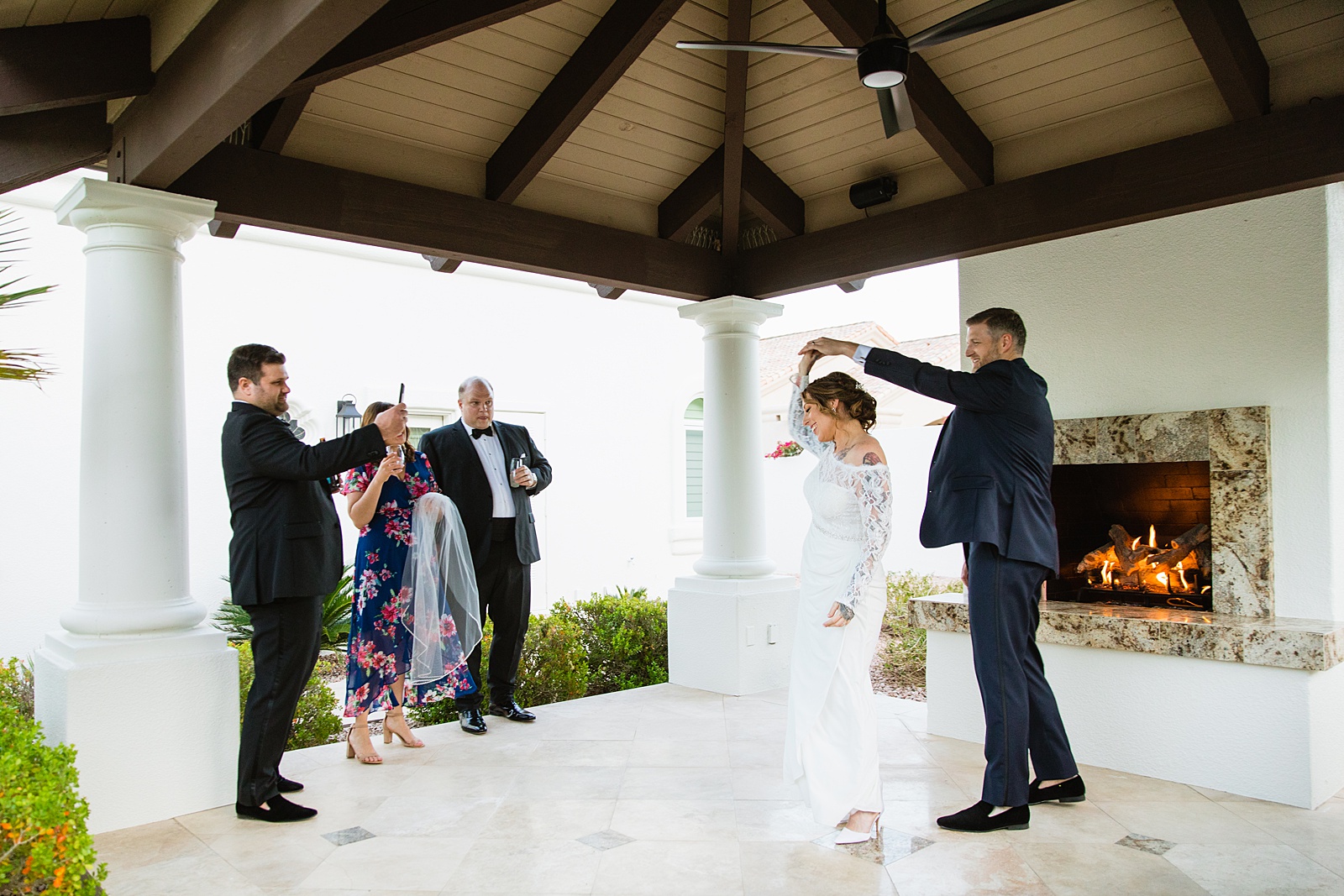 Bride and groom sharing first dance at their backyard wedding reception by Arizona wedding photographer PMA Photography.