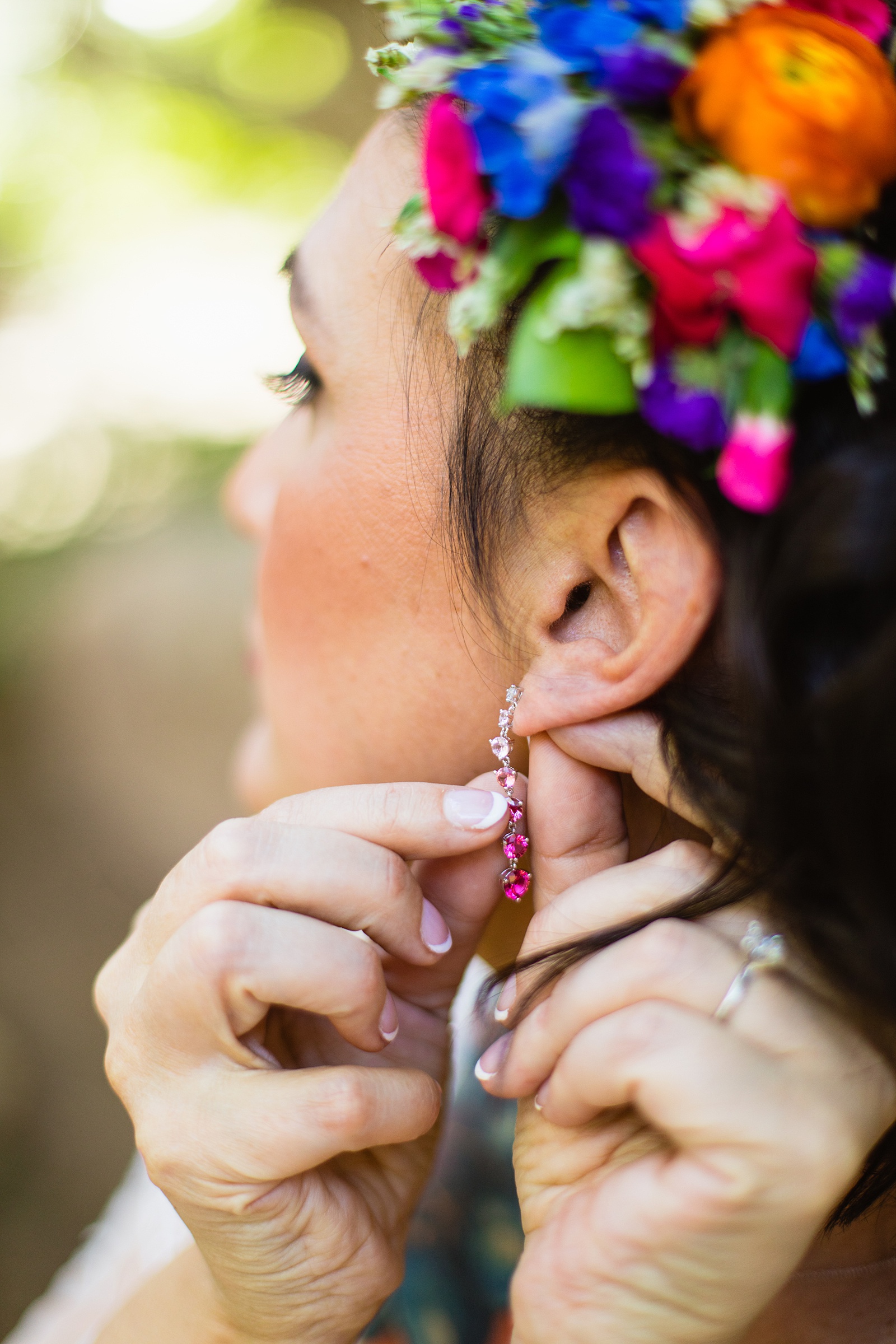 Bride adjusting her earrings on her wedding day by Phoenix wedding photographers PMA Photography.