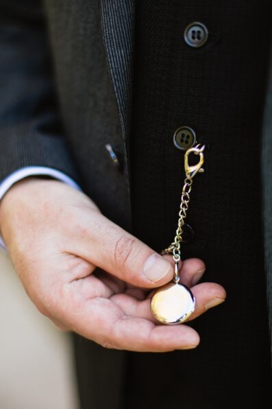 Groom's wedding day details of his pocket watch by PMA Photography.