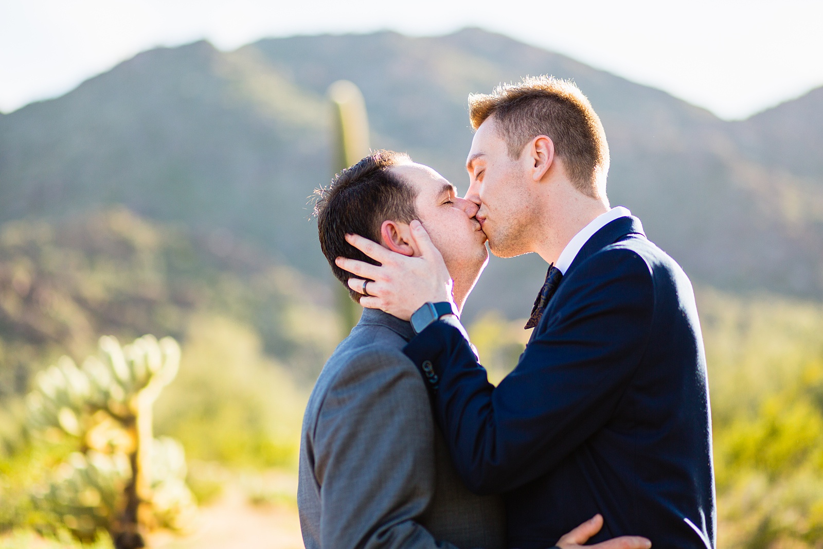 Same sex couple share a kiss during their White Tanks elopement by Phoenix elopement photographer PMA Photography.