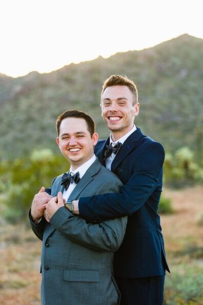 LGBTQ couple laughing together during their White Tanks elopement by Arizona elopement photographer PMA Photography.