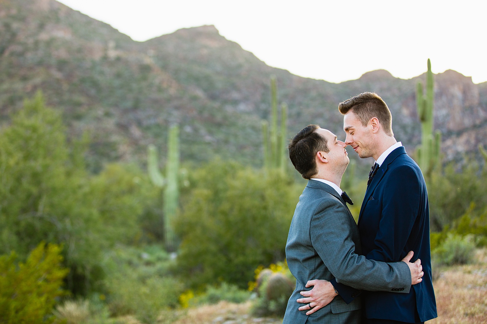 Same sex couple share an intimate moment during their White Tanks elopement by Phoenix elopement photographer PMA Photography.