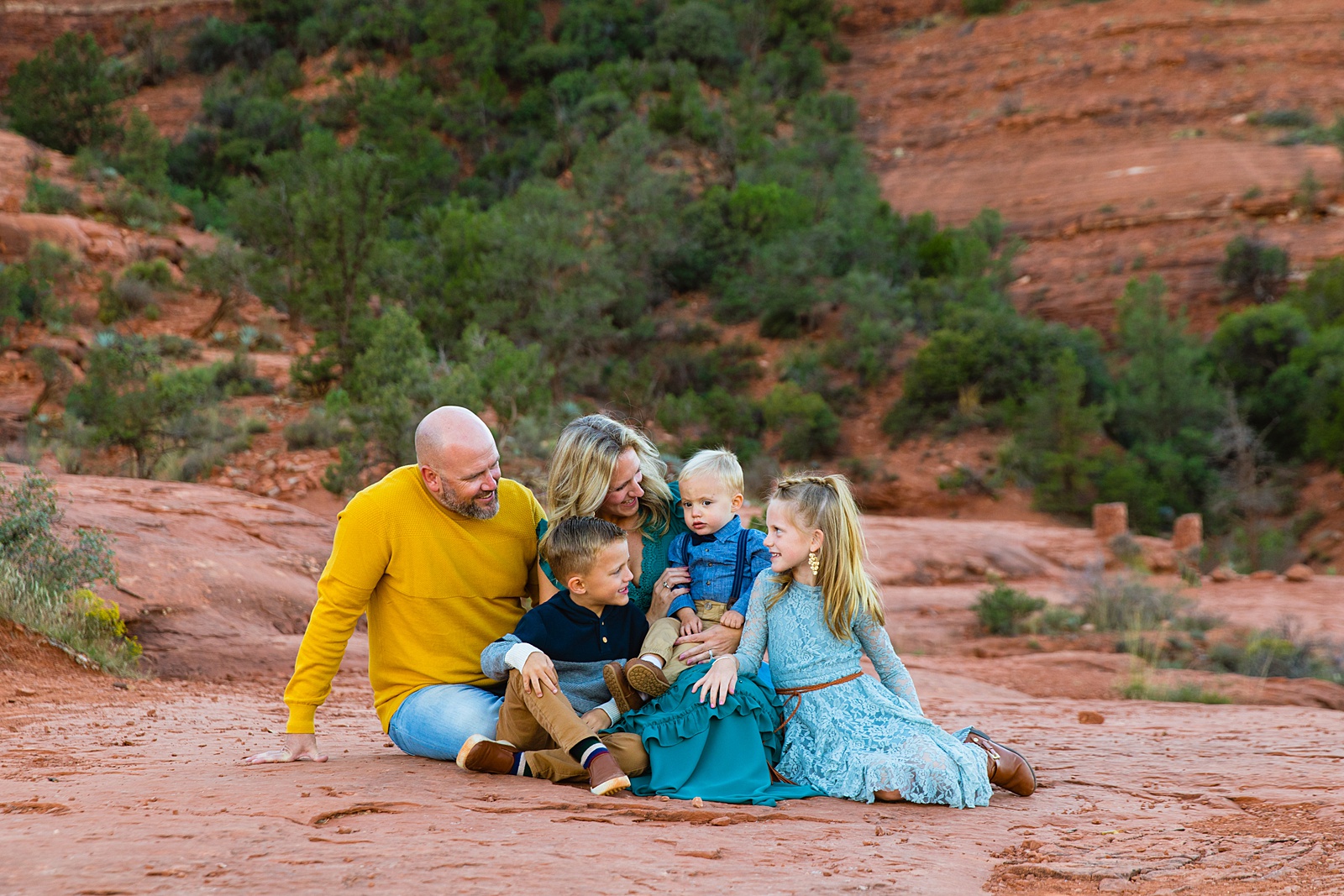 Family look at each other during their Sedona family session by Arizona family photographer PMA Photography.