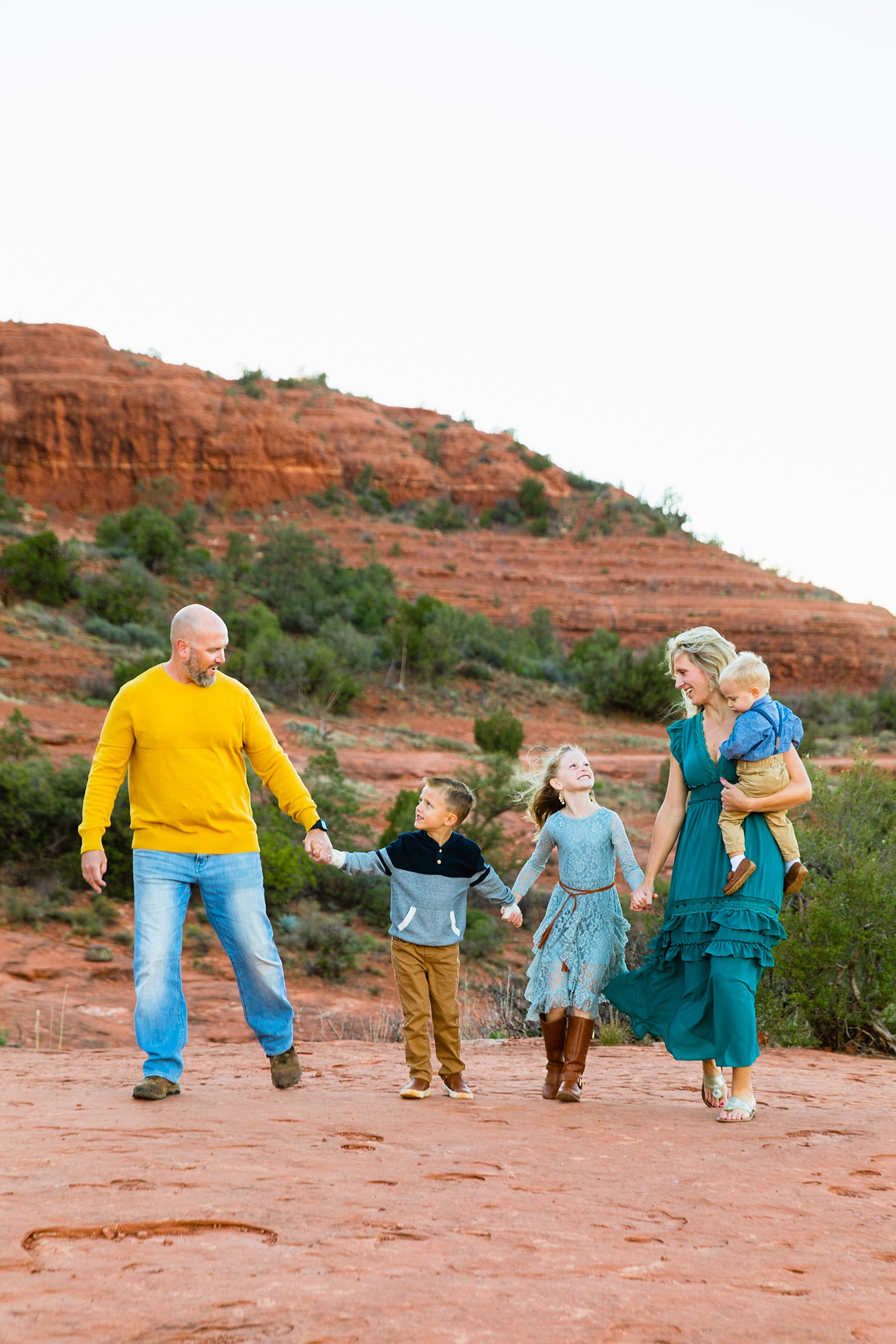 Family walking together during their Sedona family session by Arizona family photographer PMA Photography.
