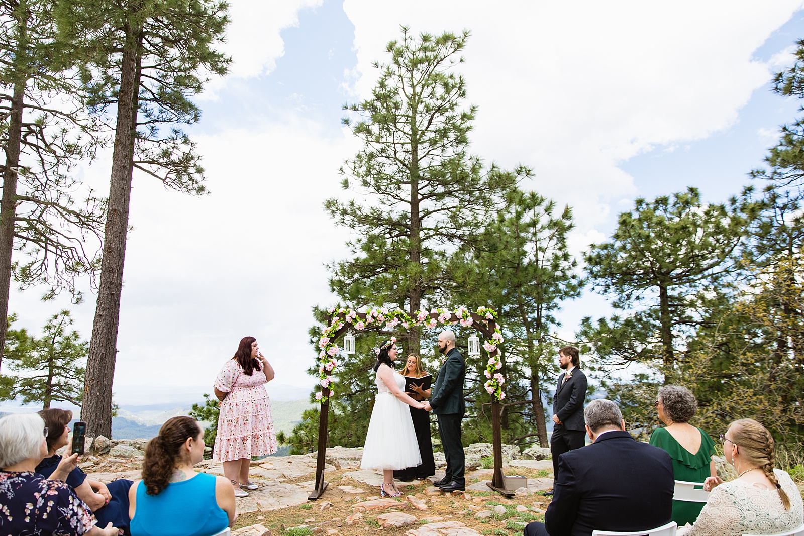 Bride & Groom togethering during Mogollon Rim wedding ceremony by Payson elopement photographer Juniper & Co.