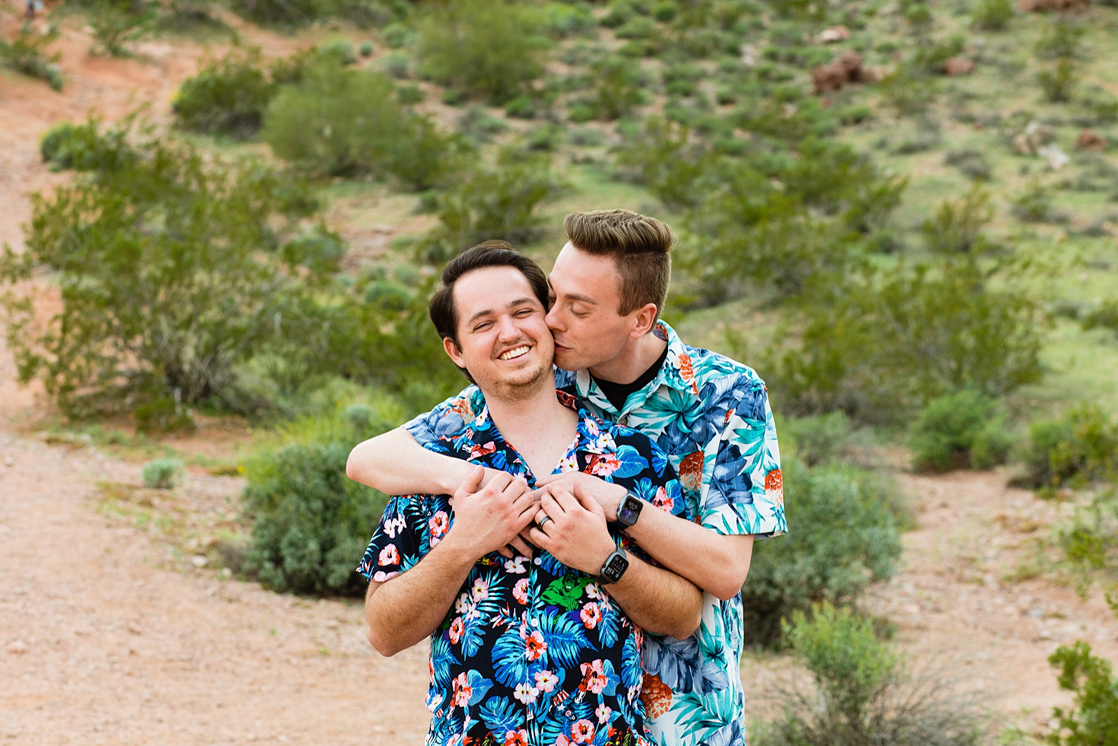 LGBTQ couple laugh together during their Tempe engagement session by Arizona engagement photographer Juniper and Co Photography.