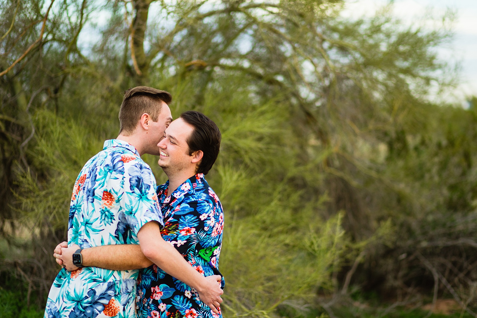 Couple laugh together during their Papago Park engagement session by Tempe engagement photographer Juniper and Co Photography.
