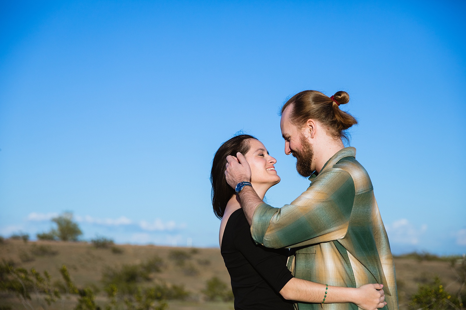 Couple look at each other during their Papago Park engagement session by Tempe wedding photographer Juniper and Co Photography.