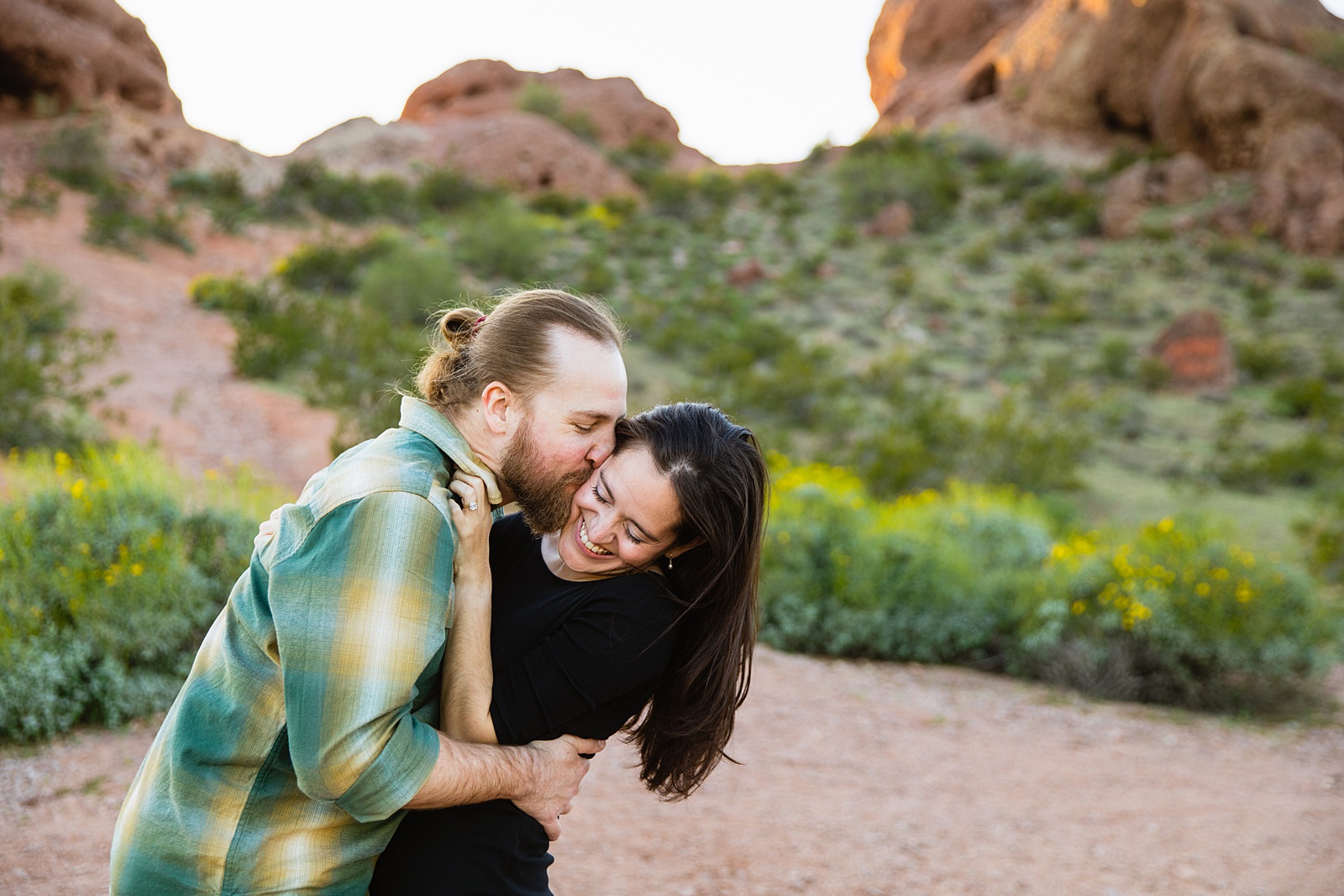 Couple having fun together during their Papago Park engagement session by Tempe engagement photographer Juniper and Co Photography.