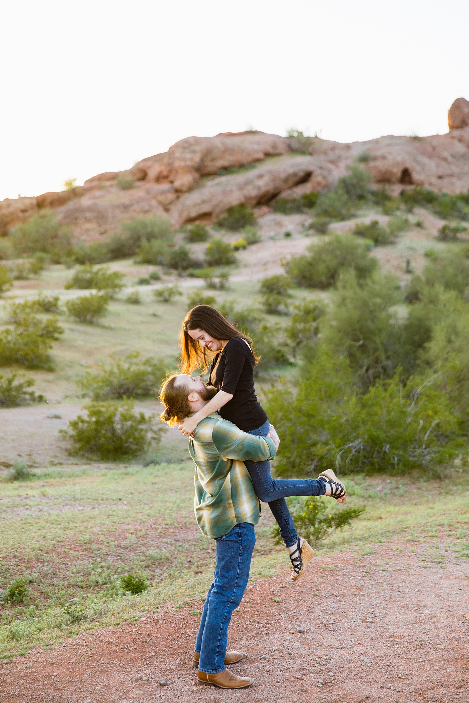 Couple having fun together during their Papago Park engagement session by Tempe engagement photographer Juniper and Co Photography.