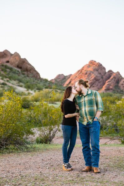 Couple share a kiss during their Tempe engagement session by Arizona wedding photographer Juniper and Co Photography.