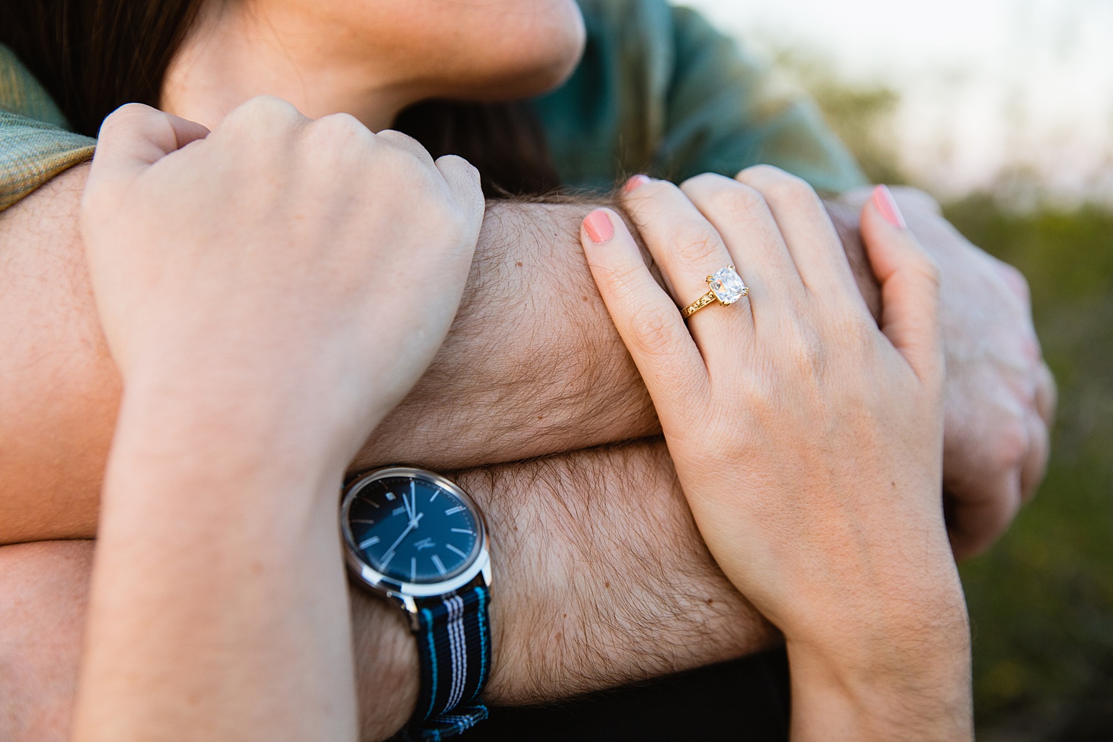 Detail image of engagement ring during during engagement session by Juniper and Co Photography.