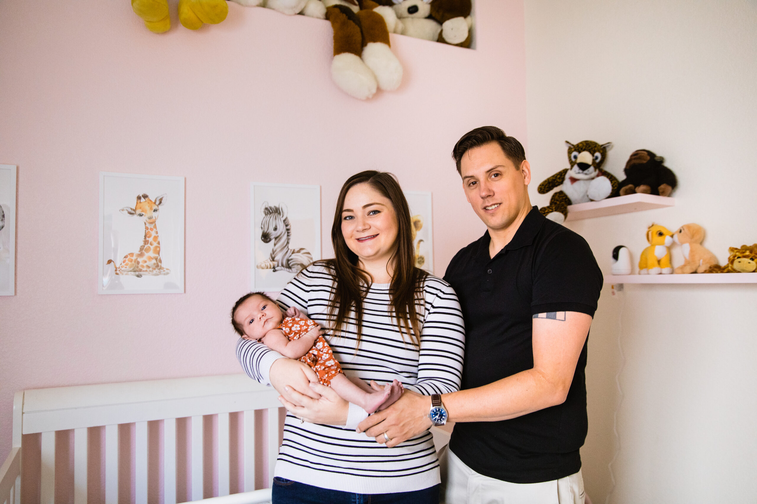 Newborn with her parents during their in-home newborn Phoenix family session by Arizona family photographer Juniper and Co Photography.