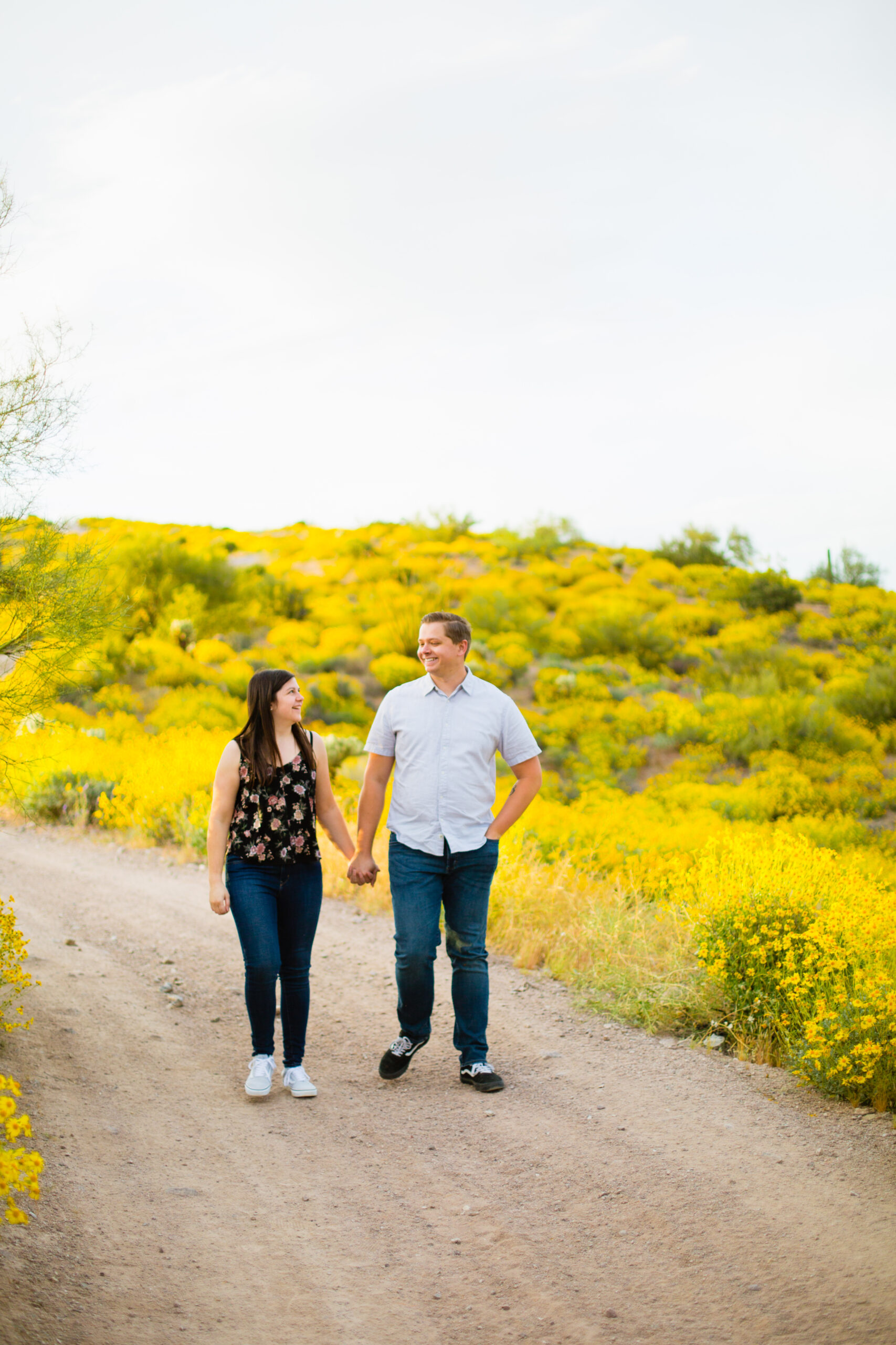 Couple walking together during their Arizona engagement session by Arizona engagement photographer Juniper and Co Photography.