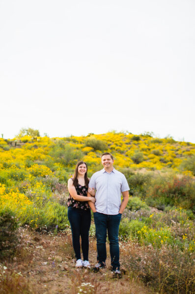Couple pose during their Arizona engagement session by Arizona wedding photographer Juniper and Co Photography.