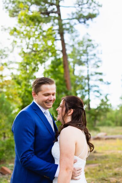 Bride & Groom laughing together during their Mogollon Rim elopement by Arizona elopement photographer Juniper and Co Photography.