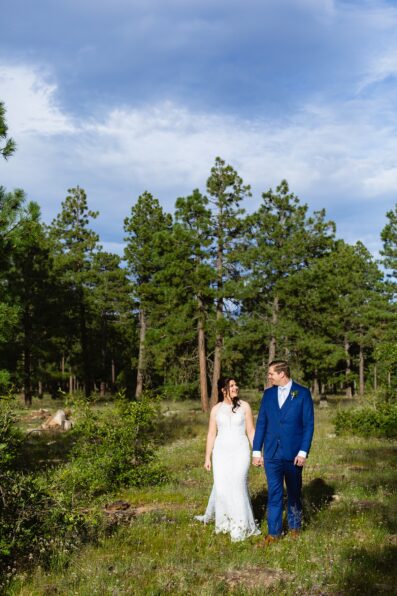 Bride & Groom walking together during their Mogollon Rim elopement by Arizona elopement photographer Juniper and Co Photography.