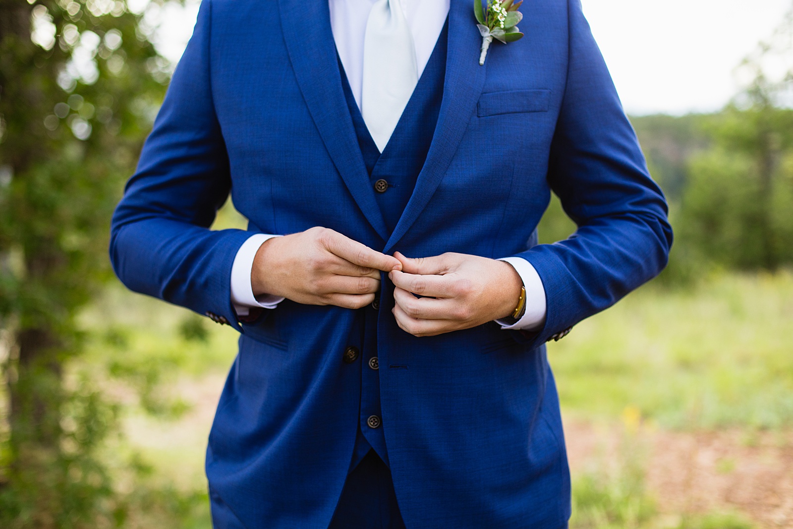 Groom's dark blue suit for his Mogollon Rim elopement by Juniper and Co Photography.