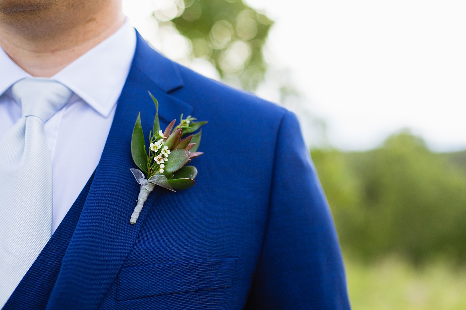 Groom's wedding day details of succulent boutonniere by Juniper and Co Photography.