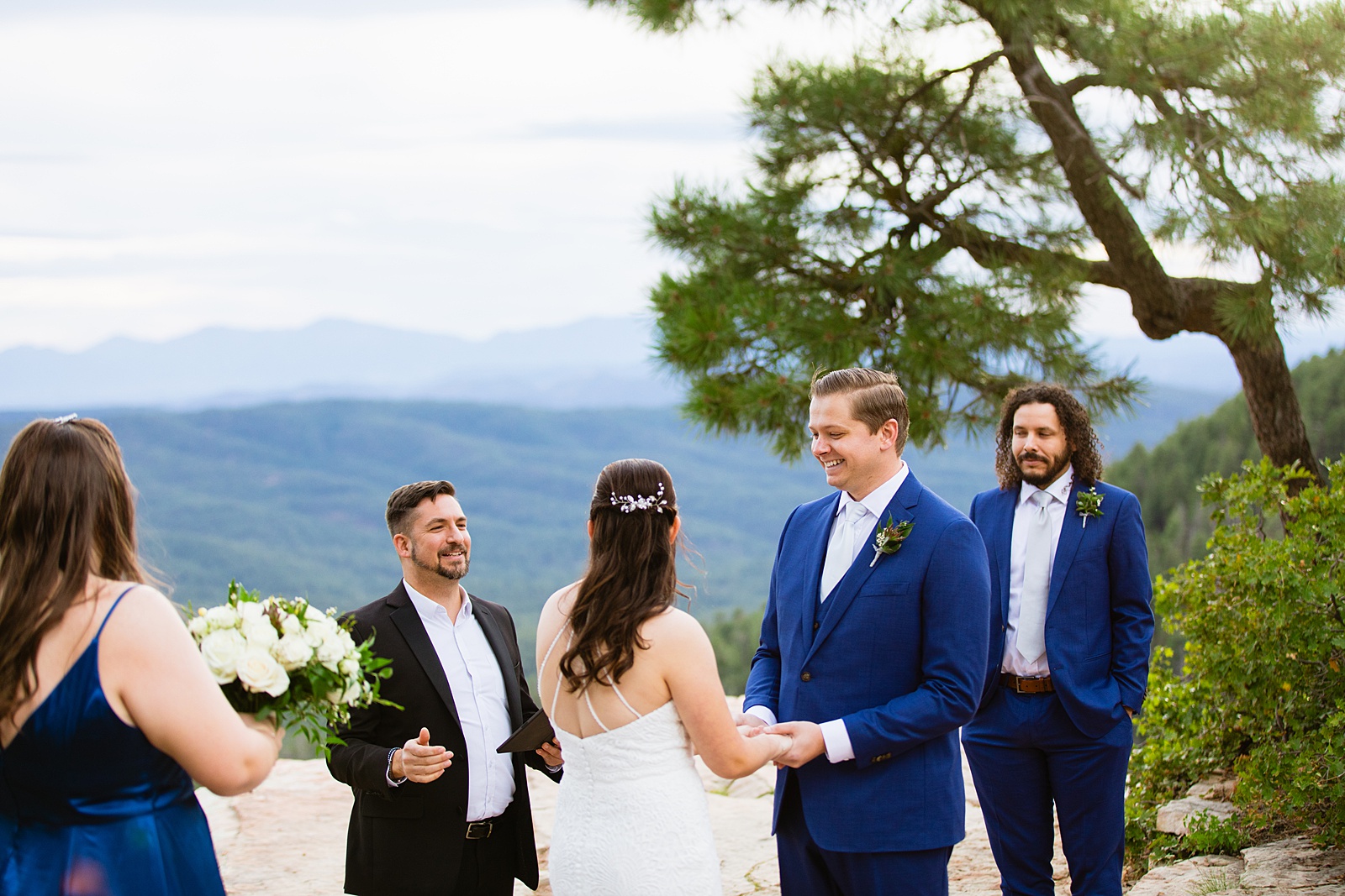 Groom looking at his bride during their wedding ceremony at Mogollon Rim by Payson elopement photographer Juniper and Co Photography.
