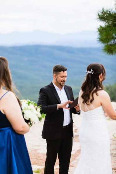 Officiant during Mogollon Rim wedding ceremony by Arizona elopement photographer Juniper and Co Photography.